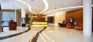 a lobby of a hotel building with a lobby at Xiamen Plaza Hotel in Xiamen