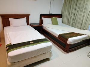 Postel nebo postele na pokoji v ubytování J Hotel Bukit Bintang + 5 fotografií