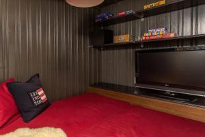 a living room with a large flat screen tv at Great mountain cabin in Sirdal with hot tub and views! in Dirdal