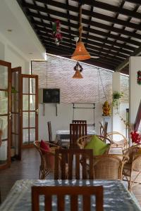 a dining room with a table and chairs at Ceylon Cecilia Villa in Galle