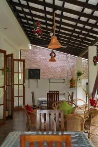 a living room with a table and chairs and a ceiling at Ceylon Cecilia Villa in Galle
