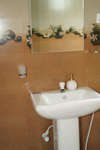 a white sink in a bathroom with a mirror at Ceylon Cecilia Villa in Galle +84 photos