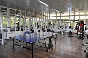 a gym with a ping pong table in the middle at Rich Hotel in Bishkek