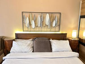 a bedroom with a bed with feathers on the wall at Apartment Centar in Podgorica