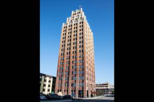 a tall brown building with a cross on top of it at The Giacomo, an Ascend Collection Hotel in Niagara Falls
