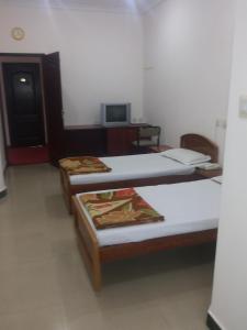 Postel nebo postele na pokoji v ubytování Hotel Nachiappa Palace