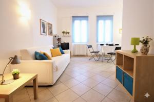a living room with a white couch and a table at Da Simona Appartamenti in Imperia