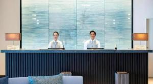 two men sitting at a bar in a room at Goto Tsubaki Hotel in Hukue