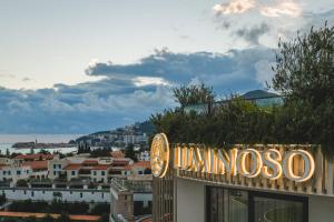 a neon sign on the side of a building at Luminoso Boutique Hotel in Budva