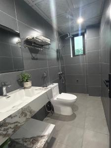 a bathroom with a toilet and a sink and a mirror at BamBoo Villa Homestay in Ninh Binh +43 photos