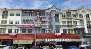 a large building with cars parked in front of it at OYO 90789 Stutong Point in Maong Bazaar