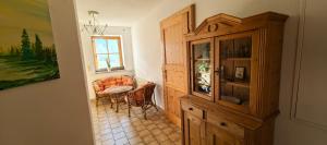 a room with a cabinet and a table and a chair at Landhaus auf der Alm in Langschlag