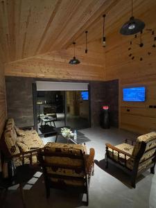 a living room with two couches and a table at Cherry hut in Ajloun