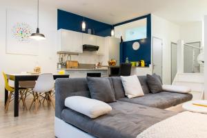 a living room with a couch and a kitchen at Unsejouranantes- Loft Cassard in Nantes