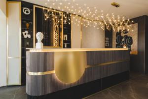 a bar in a room with lights on it at Luminoso Boutique Hotel in Budva