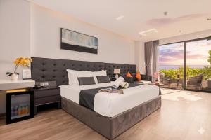 JBAY Beachfront Boutique Hotel في دا نانغ: غرفة نوم مع سرير كبير ومدفأة +110 صور