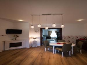 a living room with a dining room table and chairs at Luxury Central apartment in Sibiu in Sibiu