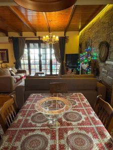 a dining room with a table and a living room at Monica's Tropical Villa in Iraklitsa