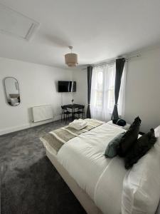 a bedroom with a large white bed with a window at The Luma Suite in Albrighton +5 photos