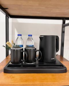 a stove with two mugs and two bottles of water at 22 Homestay-near AEON Mall 3 & Techo International Aiport in Ta Khmau