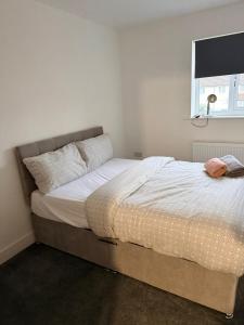 un grand lit dans une chambre avec une fenêtre dans l'établissement Modern 3 Bed with 3 Baths and Parking, Near Centre, à Bredbury