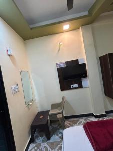 a room with a table and a chair in a room at Hotel Priyanshi Palace in Ujjain