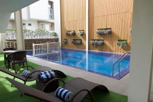 a swimming pool in the middle of a building at Verdant Villas in Kaybagal