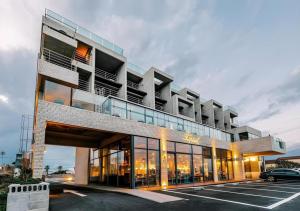 a building with a car parked in a parking lot at Tropical Hideaway in Seogwipo