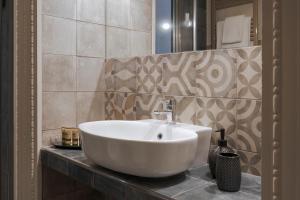 a white sink sitting on a counter in a bathroom at Belduomo Catania Rooms & Flat in Catania +23 photos