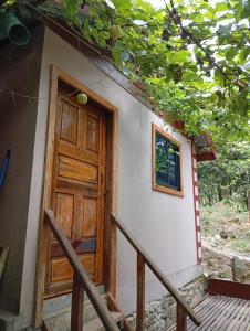 a door of a small house with a porch at Soundgarden Kohrong in Koh Rong