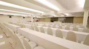 an empty lecture hall with white chairs in it at The Regent Ubon in Ban Na Khwai