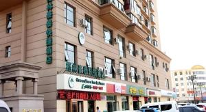 a building with a clock on the side of it at GreenTree Inn Datong YundinGYAyuan Express Hotel in Datong