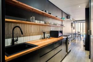 a kitchen with a sink and a counter top at Hidden Gem Llandudno Studio in Llandudno