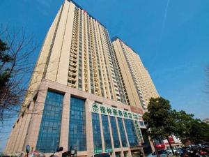 a large tall building with a lot of windows at GreenTree Inn Hefei Huangshan Road Business Hotel in Hefei