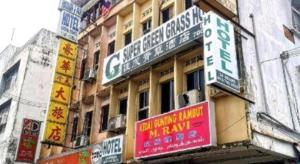 a building with signs on the side of it at SPOT ON 90625 Super Green Grass Hotel in Yong Peng +175 photos