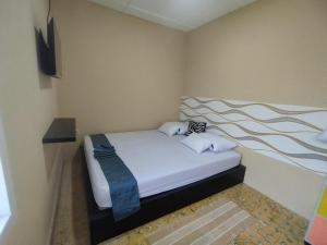 Postel nebo postele na pokoji v ubytování Arwana Inn