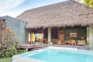 a resort with a swimming pool in front of a house at Tadhana Villa in General Luna