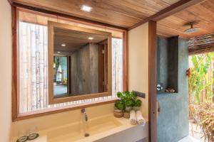 a bathroom with a large mirror and a sink at Tadhana Villa in General Luna