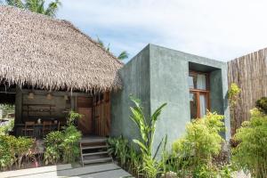 a small house with a thatched roof at Tadhana Villa in General Luna
