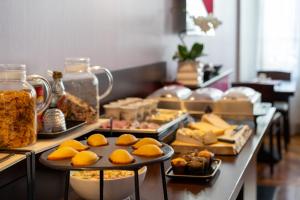 a buffet line with different types of food on at Hôtel de l'Europe Grenoble hyper-centre in Grenoble