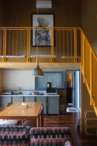 a kitchen with a dining table and a loft at Villa Cannary in Tegalharendong