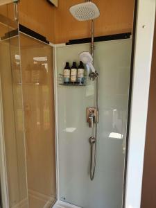 a shower in a bathroom with a glass door at Perrys South by Tiny Away in Forth