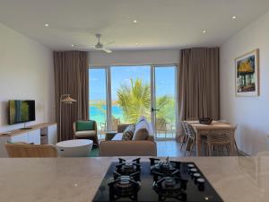 a living room with a view of the ocean at Lorlagon 2-Bedroom Beachfront Apartment by LOV Mauritius in Trou d'Eau Douce