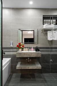 a bathroom with a sink and a mirror at Kangaroo homestay in Cat Ba