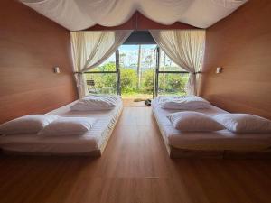 Ένα ή περισσότερα κρεβάτια σε δωμάτιο στο Hương Lúa Homestay Măng Đen