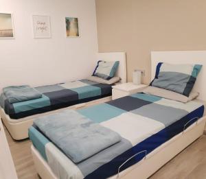 a room with two beds in a room at SeaHomes Vacations - Cala Banys Seafront Apt & PKG in Lloret de Mar