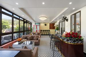 a lobby of a hotel with couches and a bar at Kangaroo homestay in Cat Ba