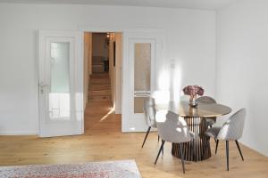 a dining room with a table and chairs at City apartment by the waterfall in Saarburg