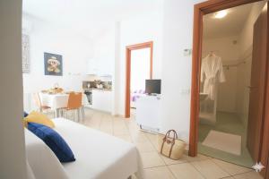 a room with a bed and a kitchen with a table at Da Simona Appartamenti in Imperia