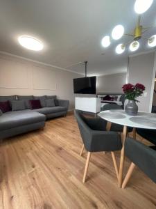a living room with a table and a couch at See- & Bergblick Oberteuringen 58 mit beheiztem Indoor-Pool in Oberteuringen